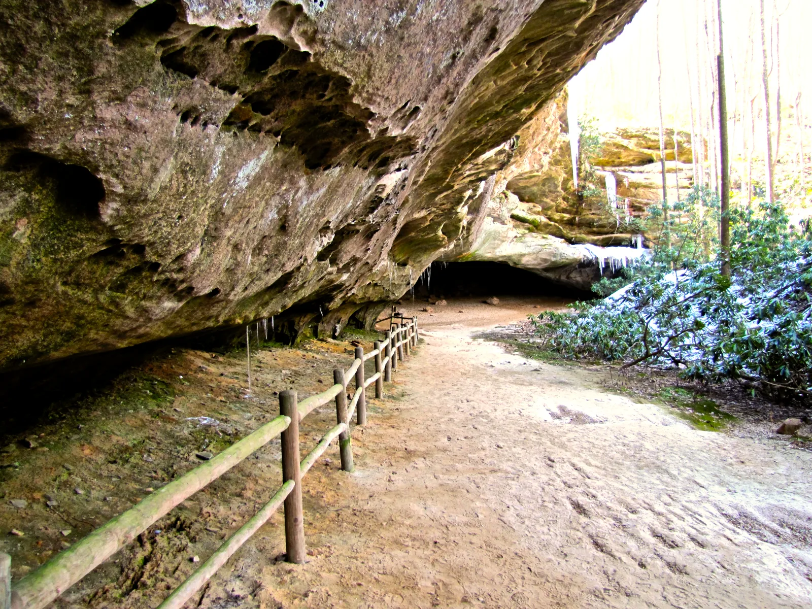 The entrance to Hazard Cave behind a protective fence railing at Pickett CCC Memorial State Park, Tennessee